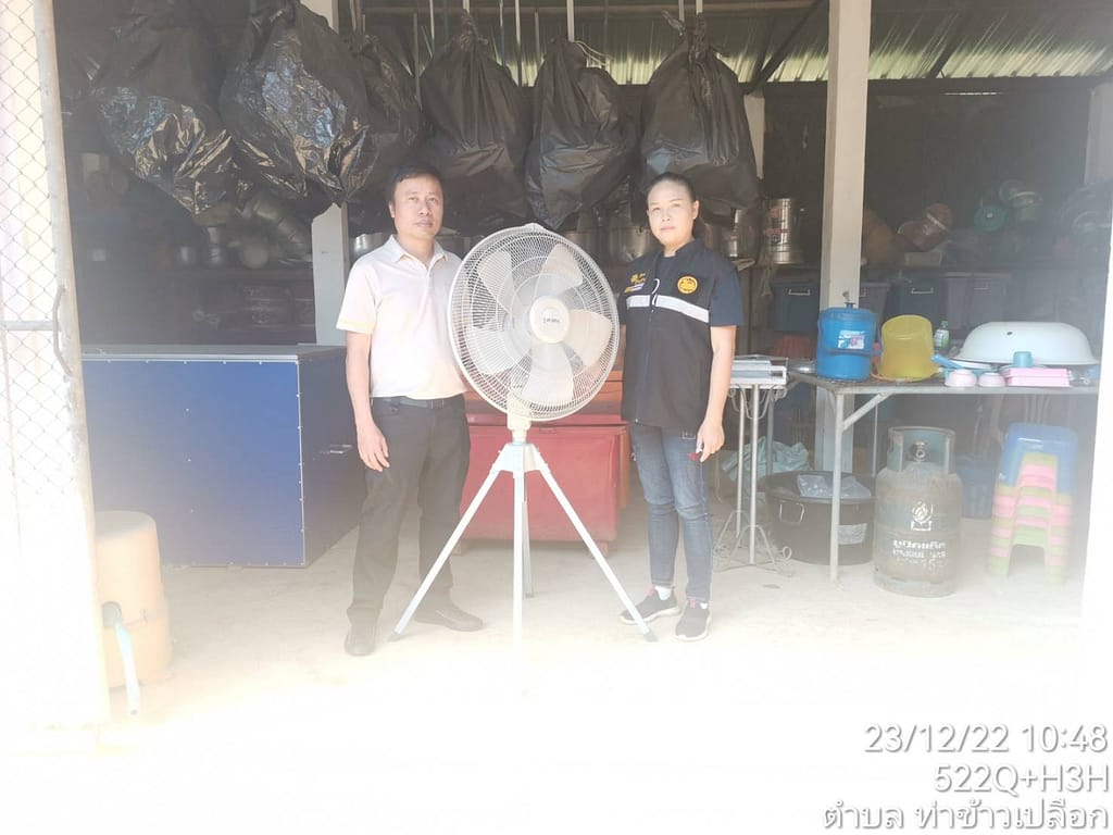 Representatives with an item (fan) that was donated to 3 neighboring villages